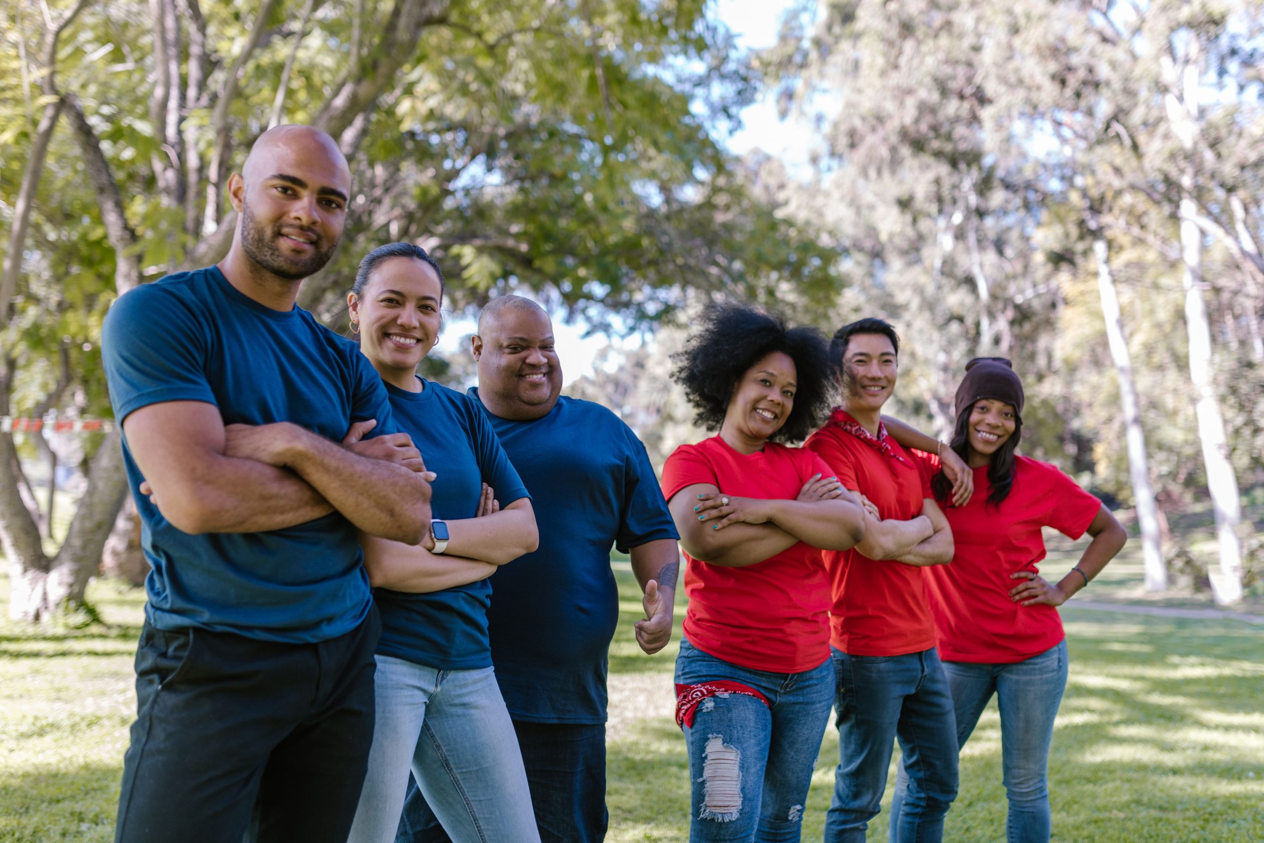Diverse group of adults bonding and enjoying team activity in a park.